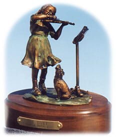 Bronze sculpture of a girl playing the violin and her dog.
