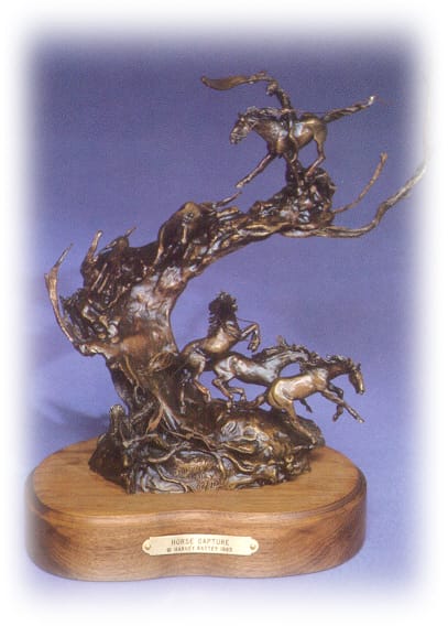 Bronze sculpture of Indians capturing horses.