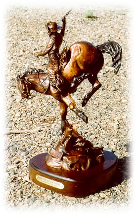 Bronze sculpture of saddle bronc rider.