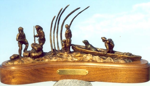 bronze sculpture of memebers of the Lewis and Clark Expedition harvesting blubber from a beached whale carcass.