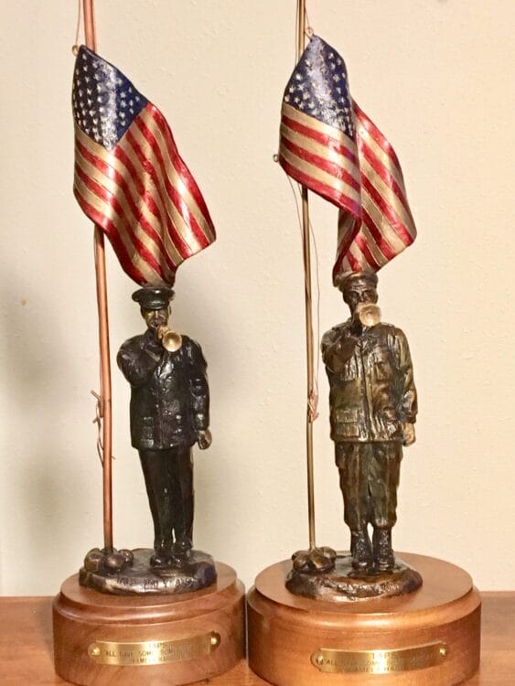 Bronze sculptures of American soldiers playing taps.