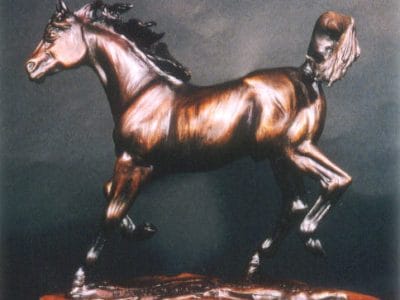 Bronze sculpture of a beautiful bay Arabian horse.