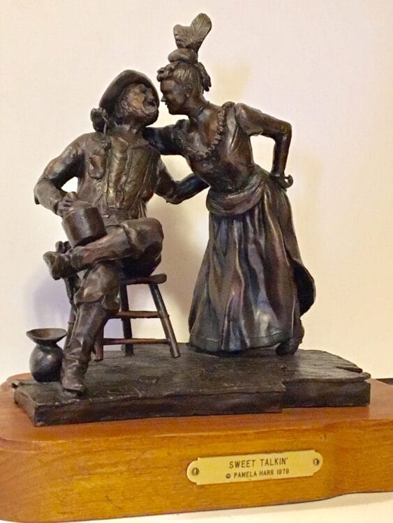An old-west cowboy in a chair and a saloon girl.